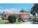 Charming single-story home with a vibrant exterior, garage and well-maintained yard at 600 Boca Ciega Isle Dr, St Pete Beach, FL 33706