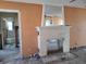 Interior view of a living room with a fireplace and unfinished walls, ready for customization at 600 Boca Ciega Isle Dr, St Pete Beach, FL 33706