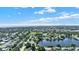 Expansive aerial view of a lush residential neighborhood with a scenic lake and cityscape in the distance at 6035 19Th Ne St, St Petersburg, FL 33703
