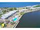 Aerial view of waterfront condos with a pool, surrounded by lush landscaping and ocean views at 611 Destiny Dr # 205, Ruskin, FL 33570