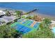 Aerial view of tennis courts and waterfront community with a fishing pier at 611 Destiny Dr # 205, Ruskin, FL 33570