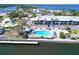 Aerial view of waterfront condos with pool and lounge area next to the bay at 611 Destiny Dr # 205, Ruskin, FL 33570