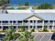 Aerial view of a coastal condo complex with balconies, lush landscaping, and parking area at 611 Destiny Dr # 205, Ruskin, FL 33570
