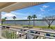Balcony view showcasing waterfront scenery with palm trees under a bright sky at 611 Destiny Dr # 205, Ruskin, FL 33570