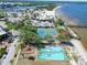Aerial view of the community including tennis courts, playground, basketball court, beach, and restaurant at 611 Destiny Dr # 205, Ruskin, FL 33570