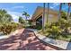 A walkway leads to the inn, framed by lush tropical landscaping at 611 Destiny Dr # 205, Ruskin, FL 33570