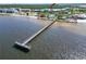 Pier extending into the water near tennis courts, playground, beach, and condo building at 611 Destiny Dr # 205, Ruskin, FL 33570