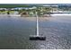 Long pier extending into the water with tennis courts, beach, and restaurant along the shoreline at 611 Destiny Dr # 205, Ruskin, FL 33570