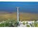 Scenic view of pier extending into the water with palm trees and greenery along the shoreline at 611 Destiny Dr # 205, Ruskin, FL 33570