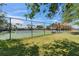 Fenced-in community tennis courts surrounded by mature trees and lush landscaping, perfect for recreation and exercise at 611 Destiny Dr # 205, Ruskin, FL 33570