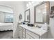 Bright bathroom featuring double sinks, modern fixtures, and view into the bedroom at 6374 Bradford Woods Dr, Zephyrhills, FL 33542