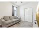 Guest bedroom featuring a comfortable sofa, closet and neutral decor at 6374 Bradford Woods Dr, Zephyrhills, FL 33542