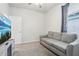 Guest bedroom featuring a comfortable sofa, closet and neutral decor at 6374 Bradford Woods Dr, Zephyrhills, FL 33542
