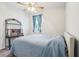Inviting bedroom with soft blue bedding, accent table, and a bright window at 6374 Bradford Woods Dr, Zephyrhills, FL 33542