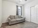 Guest bedroom featuring a comfortable sofa, closet and neutral decor at 6374 Bradford Woods Dr, Zephyrhills, FL 33542