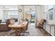 Cozy dining area with a wooden table, comfortable chairs, and sliding glass doors leading to the patio at 6374 Bradford Woods Dr, Zephyrhills, FL 33542