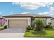 Charming single-story home with a well-manicured lawn, two-car garage, and beautiful landscaping at 6374 Bradford Woods Dr, Zephyrhills, FL 33542