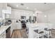 Open kitchen featuring stainless steel appliances, white cabinets, and a large island with seating at 6374 Bradford Woods Dr, Zephyrhills, FL 33542