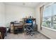 Cozy office space features a large window for natural light and neutral decor at 6374 Bradford Woods Dr, Zephyrhills, FL 33542