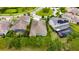An aerial view of a house featuring a screened-in pool and lush green landscaping at 6611 Current Dr, Apollo Beach, FL 33572
