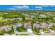 Aerial view featuring beautiful landscaping, a serene lake, and well-maintained homes at 6611 Current Dr, Apollo Beach, FL 33572