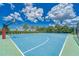 Well-maintained basketball court featuring clear blue surfaces and well-defined white lines and ample space at 6611 Current Dr, Apollo Beach, FL 33572