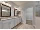 Elegant bathroom with granite countertops, dual sinks, and access to the walk-in closet at 6611 Current Dr, Apollo Beach, FL 33572