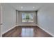 Inviting bedroom offers hardwood floors, recessed lighting, and a view of the neighborhood at 6611 Current Dr, Apollo Beach, FL 33572
