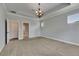 Large carpeted bedroom featuring a decorative ceiling and lots of natural light at 6611 Current Dr, Apollo Beach, FL 33572