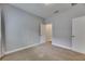Bedroom with soft carpet, neutral walls, and an open closet door at 6611 Current Dr, Apollo Beach, FL 33572