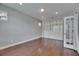 Spacious bedroom featuring hardwood floors, recessed lighting, built-in shelving, and a glass door at 6611 Current Dr, Apollo Beach, FL 33572
