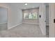 Bright bedroom with plush carpet, large window, and neutral wall color at 6611 Current Dr, Apollo Beach, FL 33572
