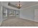 Large carpeted bedroom featuring a decorative ceiling and lots of natural light at 6611 Current Dr, Apollo Beach, FL 33572