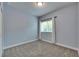 Light-filled bedroom with window and neutral wall-to-wall carpet at 6611 Current Dr, Apollo Beach, FL 33572