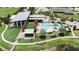 Stunning aerial view of community pool, featuring a modern clubhouse, pool, patio, and meticulous landscaping at 6611 Current Dr, Apollo Beach, FL 33572