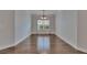 A bright dining room with hardwood floors, white trim, and a large window overlooking the green outdoors at 6611 Current Dr, Apollo Beach, FL 33572