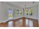 Bright dining room with hardwood floors, natural light, and modern window treatments at 6611 Current Dr, Apollo Beach, FL 33572