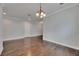Dining room featuring hardwood floors, crown molding, and classic light fixture at 6611 Current Dr, Apollo Beach, FL 33572