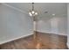 Dining room features hardwood floors, crown molding, and a classic chandelier at 6611 Current Dr, Apollo Beach, FL 33572