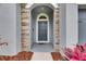 Close-up of the home's front door with stone surround and updated hardware at 6611 Current Dr, Apollo Beach, FL 33572
