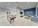 Entertainment game room featuring a shuffleboard table, lounge area, and a TV for group entertainment at 6611 Current Dr, Apollo Beach, FL 33572
