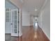 An open hallway features hardwood floors, recessed lighting, and double doors leading to another room at 6611 Current Dr, Apollo Beach, FL 33572