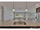Open concept kitchen with granite counters, stainless steel sink, and a view of the living area at 6611 Current Dr, Apollo Beach, FL 33572