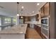 Modern kitchen featuring stainless appliances, granite counters and hardwood floors at 6611 Current Dr, Apollo Beach, FL 33572