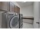 Laundry room with a new washer and dryer, and a gray countertop perfect for folding your laundry at 6611 Current Dr, Apollo Beach, FL 33572