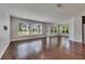 Open-concept living room with hardwood floors and large windows offering ample natural light at 6611 Current Dr, Apollo Beach, FL 33572