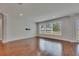 Bright living room with hardwood floors and large windows offering outdoor views at 6611 Current Dr, Apollo Beach, FL 33572