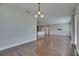 Open concept living room with kitchen and hardwood floors at 6611 Current Dr, Apollo Beach, FL 33572