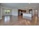 Bright living room and kitchen with wood floors, stainless appliances, and a center island at 6611 Current Dr, Apollo Beach, FL 33572