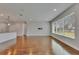 Open living space with hardwood floors and a large window overlooking the backyard at 6611 Current Dr, Apollo Beach, FL 33572